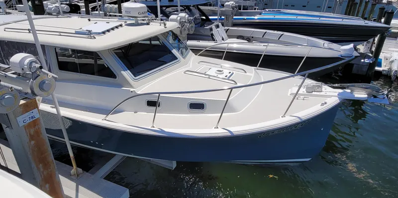 Slide: The Image of Eastport 32 OBX 2015 motorboat docked at marina. - 4