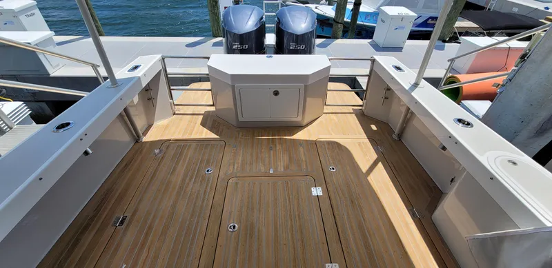 Slide: The Image of Eastport 32 OBX 2015 with wooden deck and outboard motors. - 5