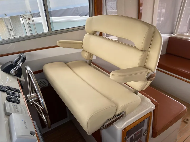 Slide: The Image of Helm station of 2015 Eastport 32 OBX with beige seat. - 6