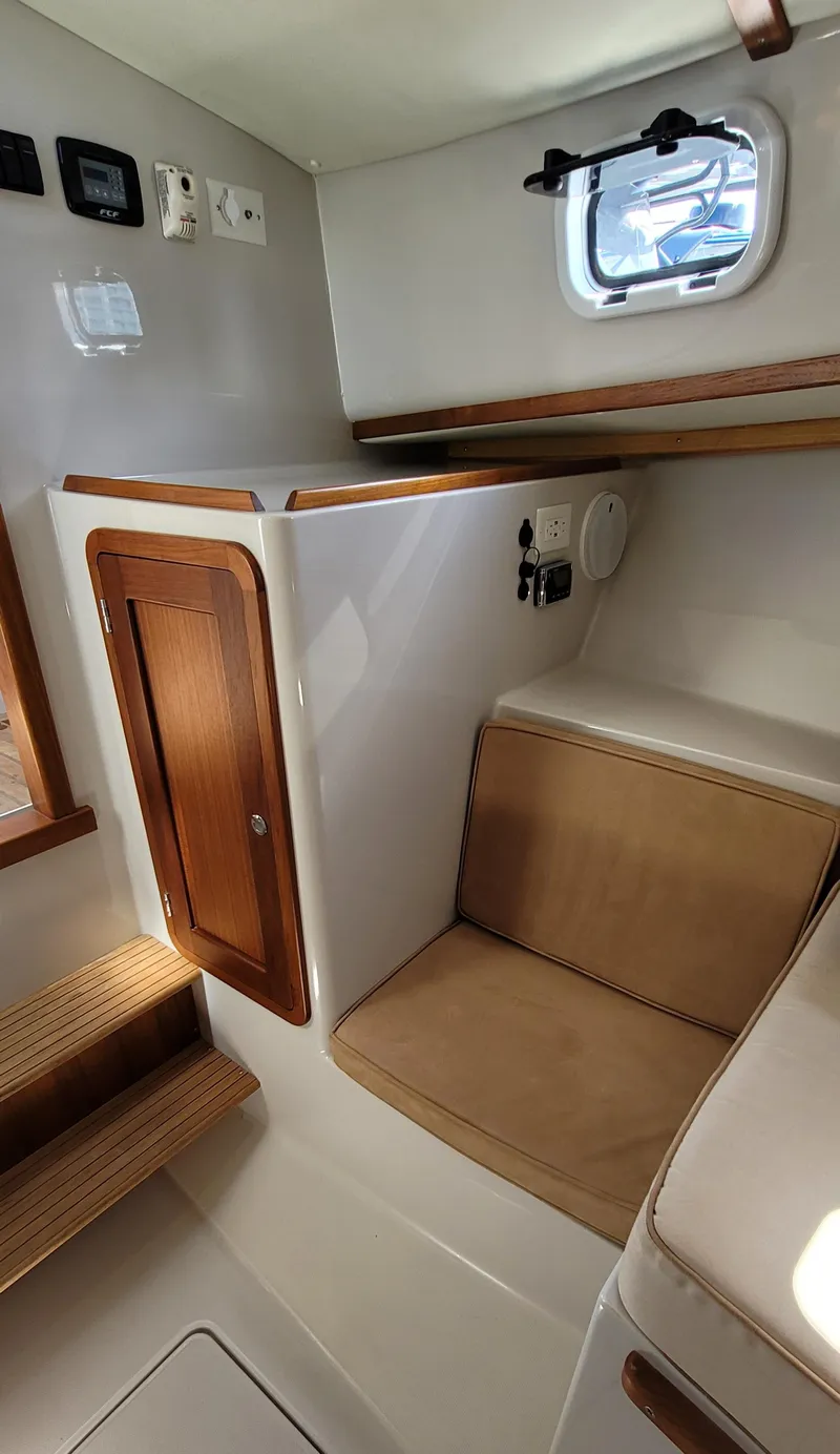 Slide: The Image of Interior of 2015 Eastport 32 OBX yacht with seating area and window. - 9