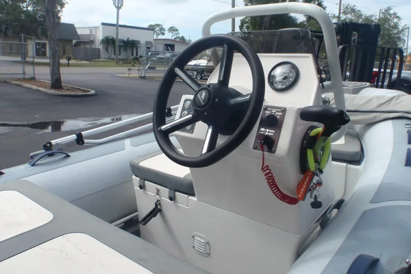 Slide: The Image of 2022 Highfield Classic 360 GT boat interior with steering wheel and control panel. - 2