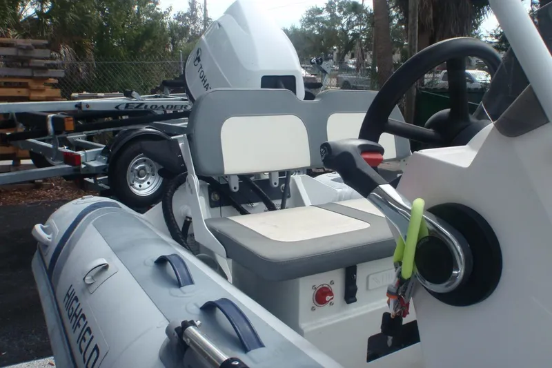 Slide: The Image of 2022 Highfield Classic 360 GT boat interior with steering wheel and seating. - 4