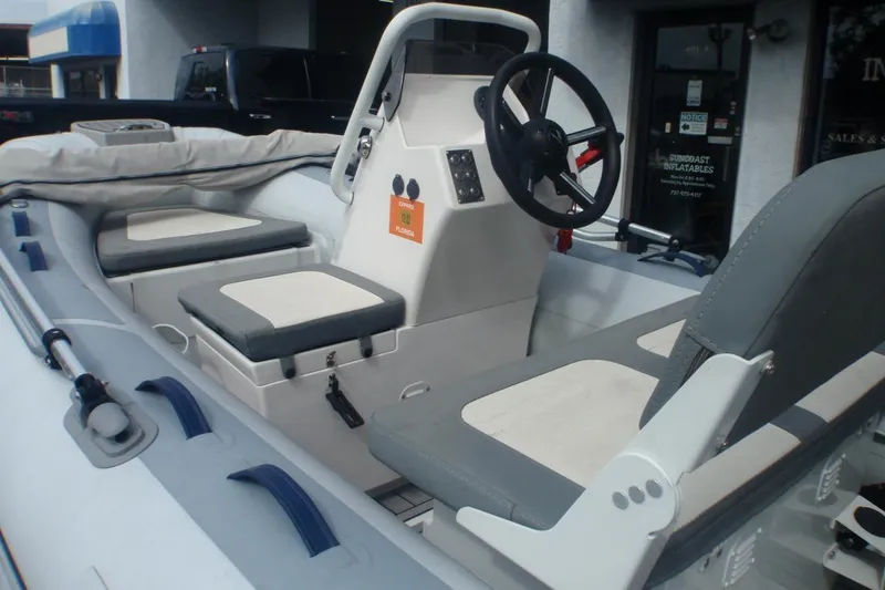 Slide: The Image of 2022 Highfield Classic 360 GT boat interior with steering wheel and seating. - 6