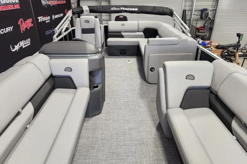 Slide: The Image of Interior view of a 2026 Sun Tracker Party Barge 20 DLX pontoon boat with gray seating. - 10