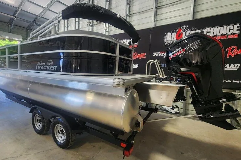 Slide: The Image of 2026 Sun Tracker Party Barge 20 DLX pontoon boat with Mercury Pro XS engine in showroom. - 4
