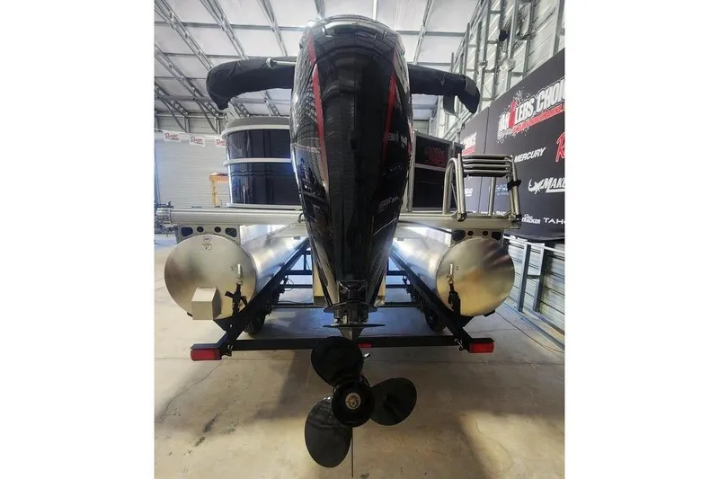 Slide: The Image of 2026 Sun Tracker Party Barge 20 DLX pontoon boat in a showroom, rear view. - 6