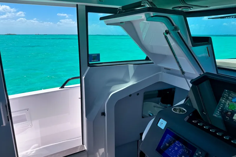 Slide: The Image of Interior view of 2025 Axopar 37 XC Cross Cabin with turquoise ocean backdrop. - 10