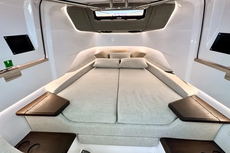 Slide: The Image of Luxurious cabin interior of 2025 Axopar 37 XC Cross Cabin with plush bedding. - 13