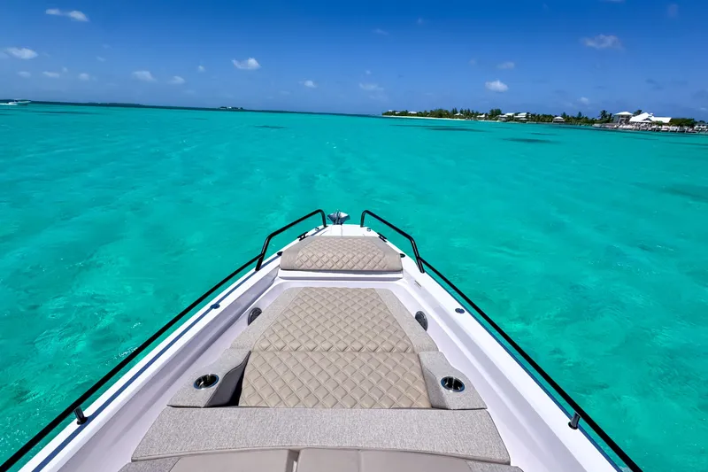 Slide: The Image of Bow view of 2025 Axopar 37 XC Cross Cabin on turquoise waters. - 16