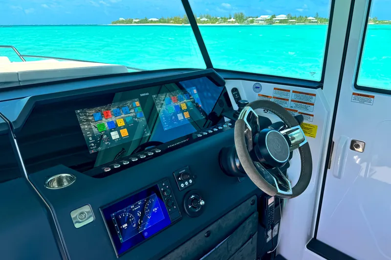 Slide: The Image of Interior view of 2025 Axopar 37 XC Cross Cabin with advanced navigation system. - 8