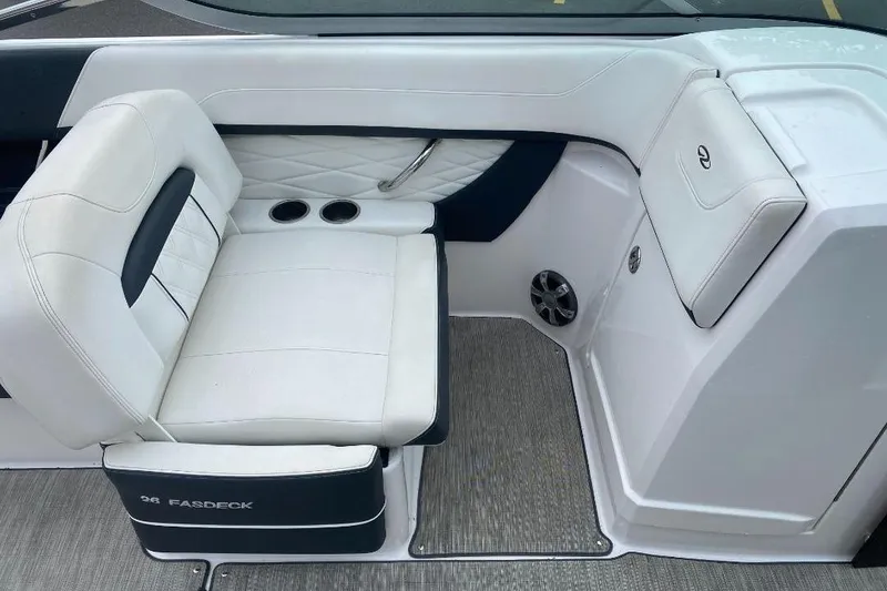Slide: The Image of 2018 Regal 26 FasDeck boat interior with white seating and cup holders. - 10