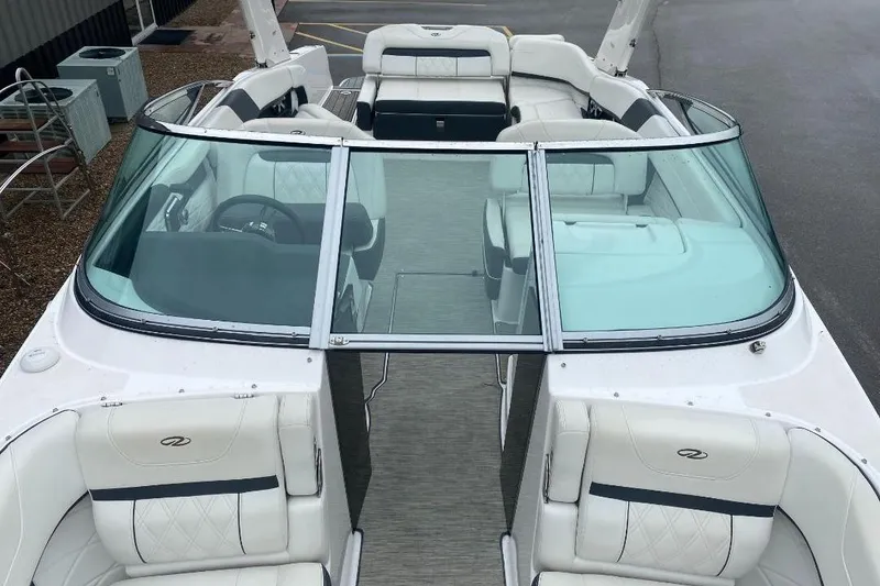 Slide: The Image of 2018 Regal 26 FasDeck boat with white seating and glass windshield. - 14