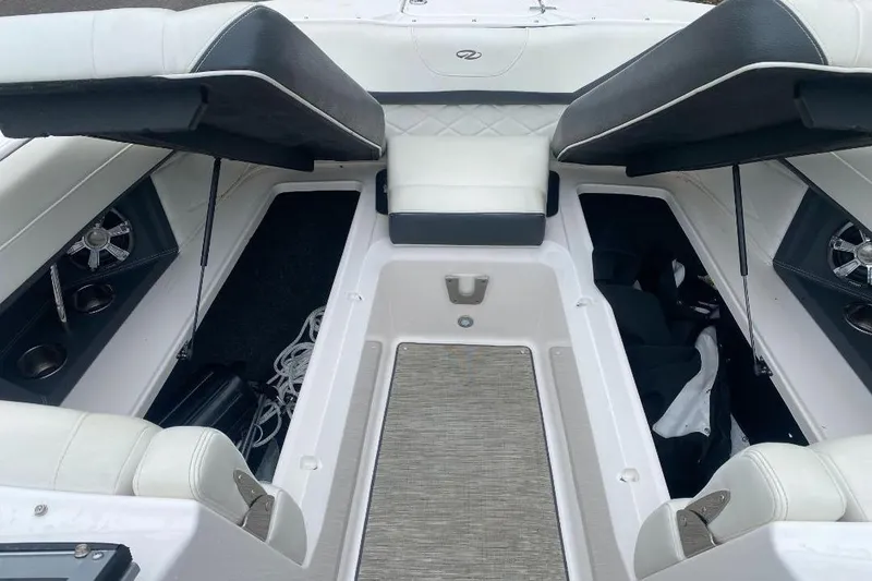 Slide: The Image of Interior view of a 2018 Regal 26 FasDeck boat with open storage compartments. - 16