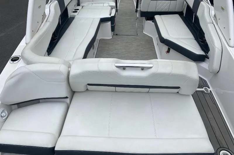 Slide: The Image of 2018 Regal 26 FasDeck boat interior with white seating and spacious layout. - 5