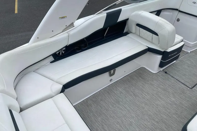 Slide: The Image of Interior seating of a 2018 Regal 26 FasDeck boat, featuring white and black upholstery. - 8