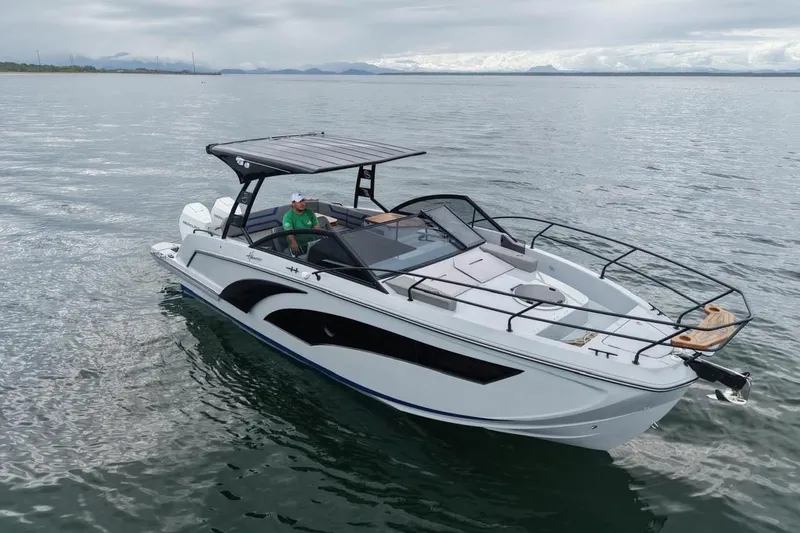 The Image of 2027 Hanover 327 boat on calm water, featuring sleek design and spacious deck. - 0