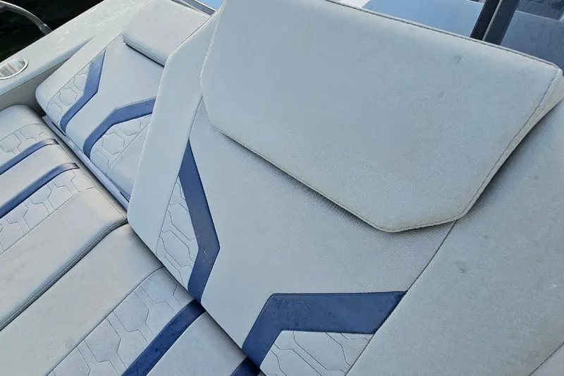 Slide: The Image of 2027 Hanover 327 boat interior with modern blue and white upholstery design. - 13