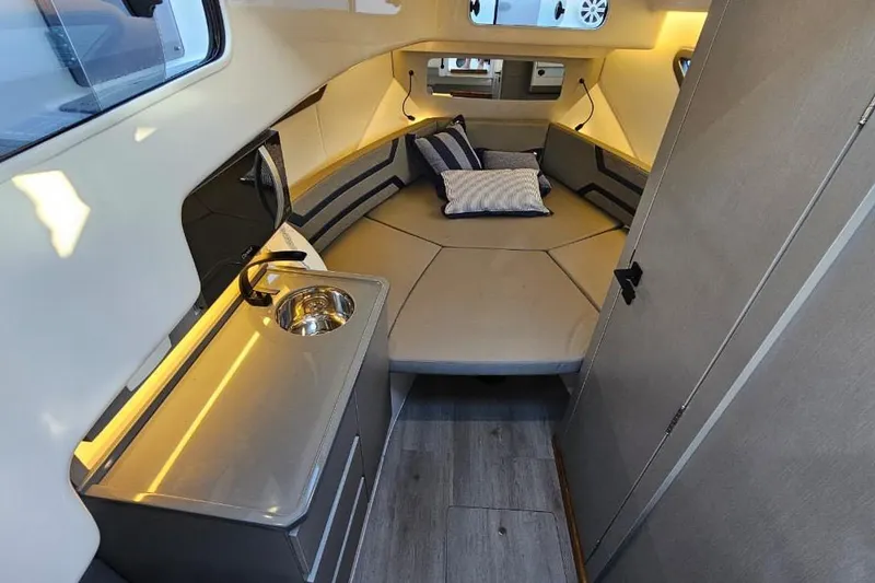 Slide: The Image of Modern interior of 2027 Hanover 327 boat with cozy seating and compact kitchenette. - 14