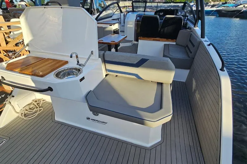 Slide: The Image of Luxurious Hanover 327 boat interior with seating, sink, and wooden accents, docked by the water. - 18