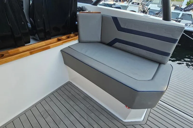 Slide: The Image of Gray seating on Hanover 327 boat, 2027 model, with wooden accents and modern design. - 19