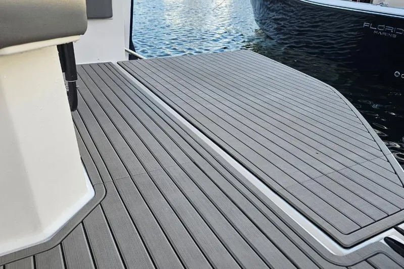 Slide: The Image of Boat deck of Hanover 327, 2027 model, with sleek gray flooring by the water. - 20