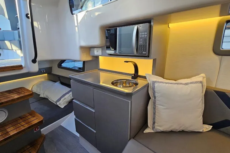 Slide: The Image of Modern Hanover 327 yacht interior with kitchenette, cozy seating, and ambient lighting, 2027 model. - 22