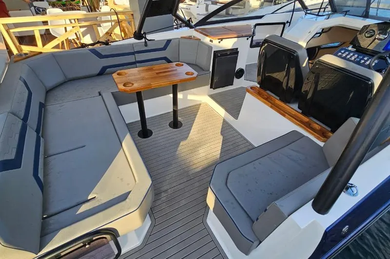 Slide: The Image of Luxurious 2027 Hanover 327 boat interior with gray seating and wooden accents. - 23