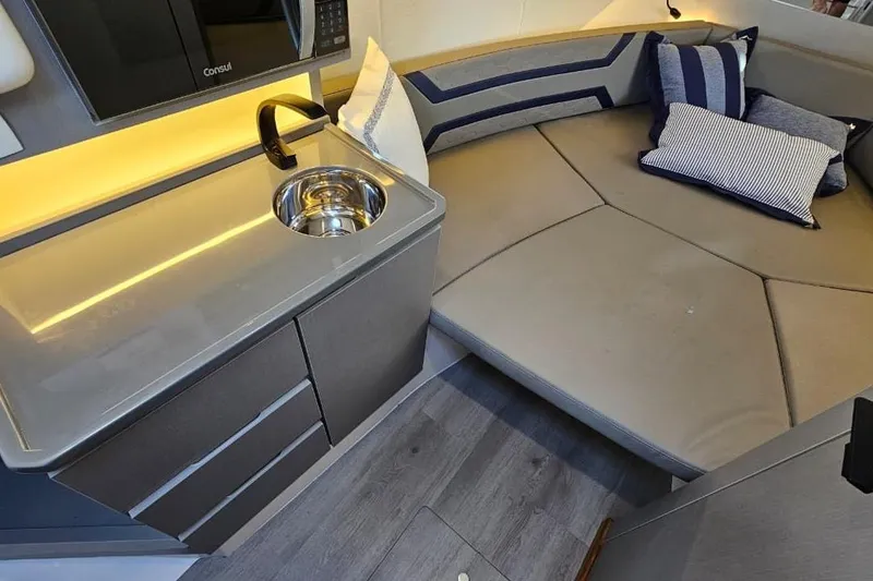 Slide: The Image of Modern Hanover 327 interior with kitchenette, sink, and cozy seating area, 2027 model. - 29
