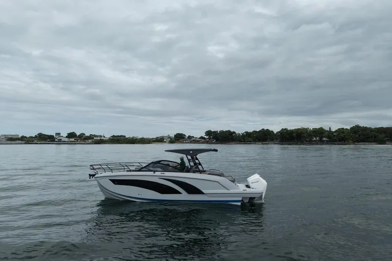 Slide: The Image of 2027 Hanover 327 boat on calm water under cloudy sky. - 3