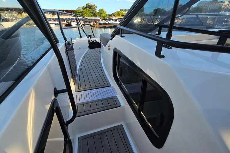 Slide: The Image of 2027 Hanover 327 boat deck with sleek design and modern railings at a marina. - 31