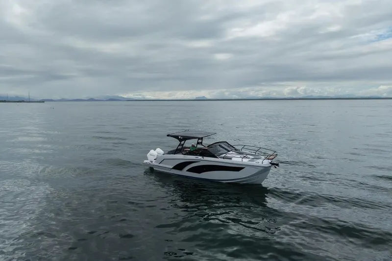Slide: The Image of 2027 Hanover 327 boat cruising on calm waters under cloudy skies. - 4