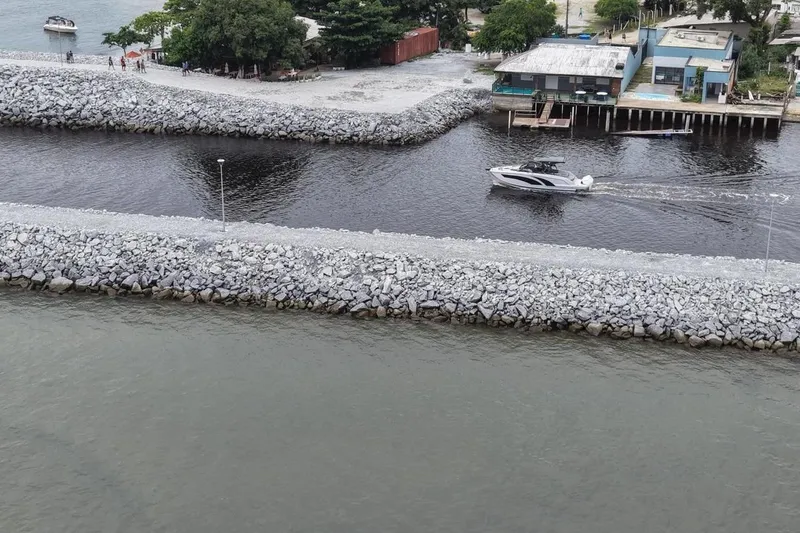 Slide: The Image of Aerial view of a Hanover 327 boat cruising between rocky barriers, 2027 model. - 5