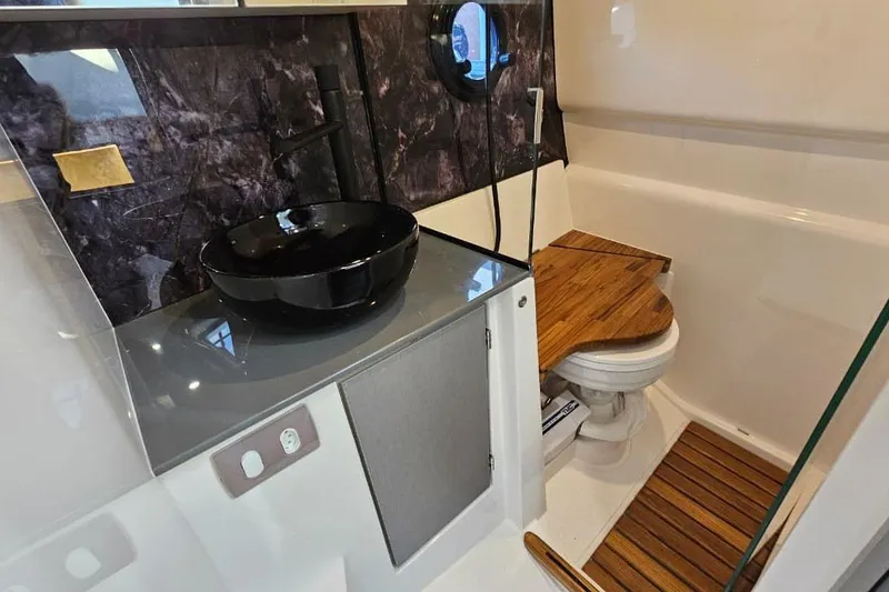 Slide: The Image of Luxurious bathroom in 2027 Hanover 327 model, featuring modern sink and wooden accents. - 6