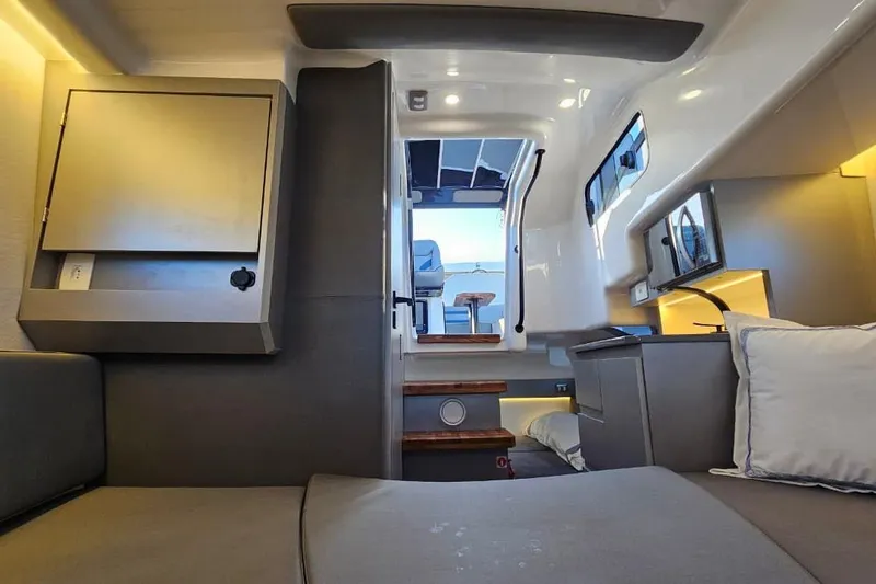 Slide: The Image of Interior of 2027 Hanover 327 boat, featuring modern design and cozy seating area. - 9