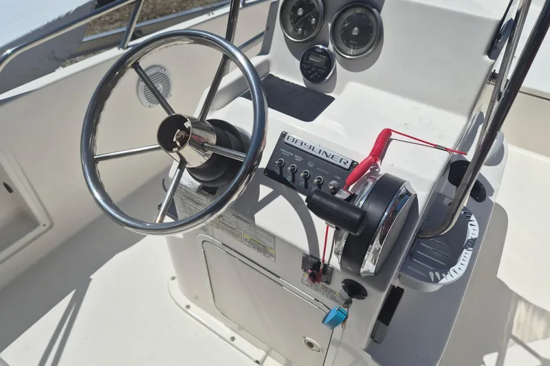 Slide: The Image of 2017 Bayliner Element F18 boat console with steering wheel and control panel. - 12