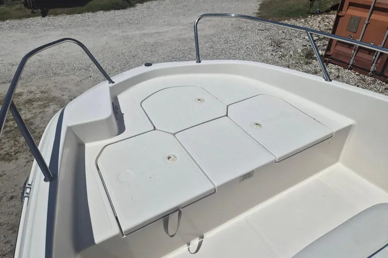 Slide: The Image of 2017 Bayliner Element F18 boat deck with storage compartments and railing. - 16