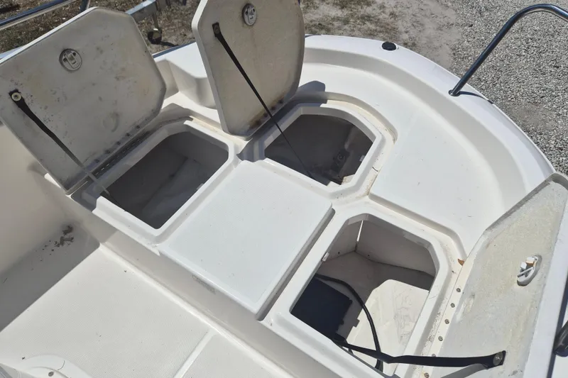 Slide: The Image of Open storage compartments on a 2017 Bayliner Element F18 boat deck. - 17