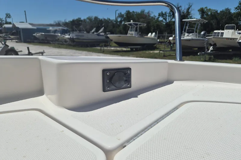 Slide: The Image of 2017 Bayliner Element F18 boat deck with railing, in a marina setting. - 18