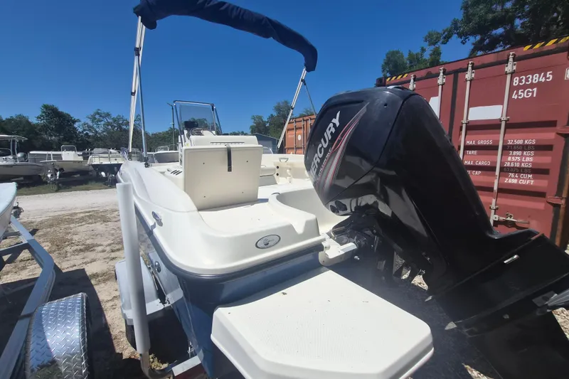 Slide: The Image of 2017 Bayliner Element F18 boat with Mercury outboard motor, parked outdoors. - 3