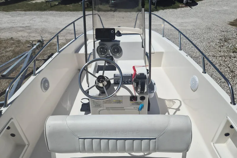 Slide: The Image of 2017 Bayliner Element F18 boat interior with steering wheel and control panel. - 5