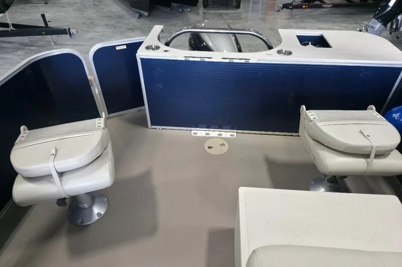 Slide: The Image of 2018 Manitou 22 Aurora LE Angler interior with two swivel seats and storage area. - 10