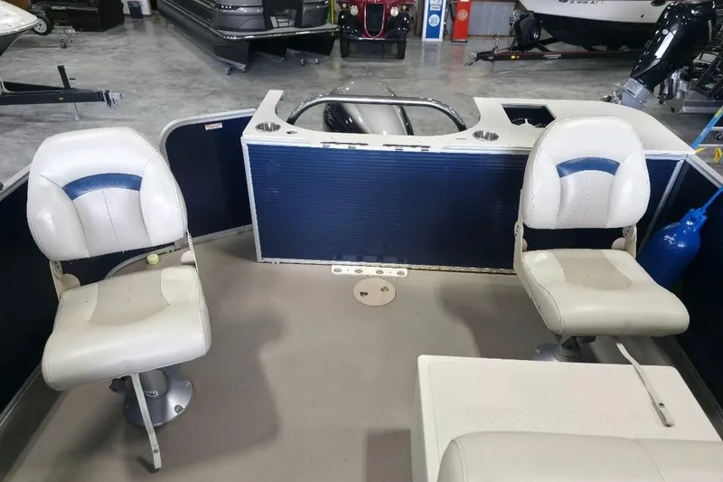 Slide: The Image of 2018 Manitou 22 Aurora LE Angler boat interior with two swivel seats. - 11