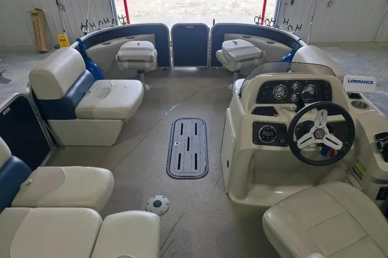 Slide: The Image of 2018 Manitou 22 Aurora LE Angler pontoon boat interior with seating and control panel. - 12