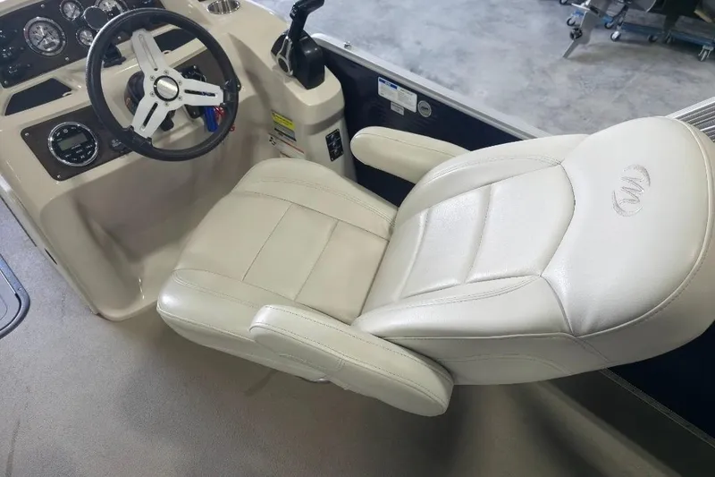 Slide: The Image of Captain's seat and dashboard of 2018 Manitou 22 Aurora LE Angler boat. - 13