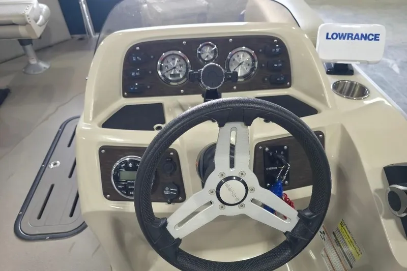 Slide: The Image of 2018 Manitou 22 Aurora LE Angler dashboard with steering wheel and Lowrance display. - 14