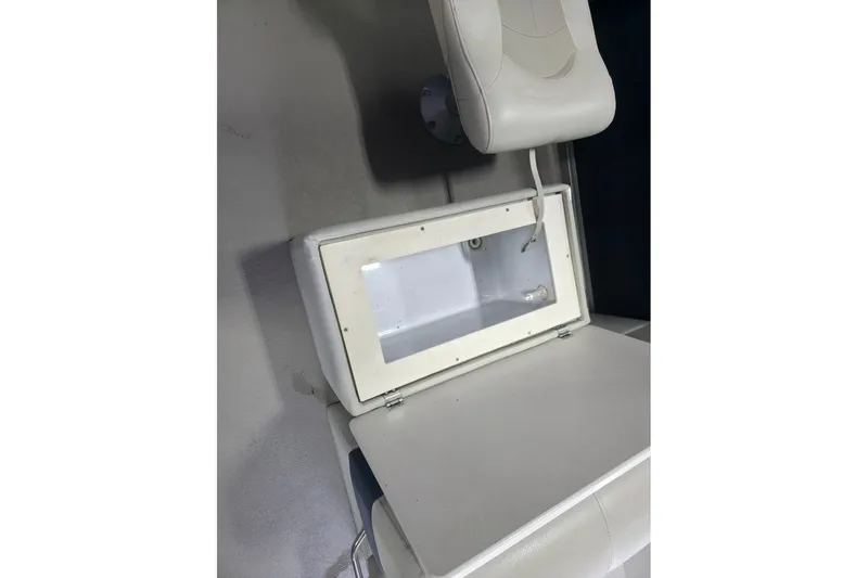 Slide: The Image of Open storage compartment on 2018 Manitou 22 Aurora LE Angler boat, featuring white interior. - 17