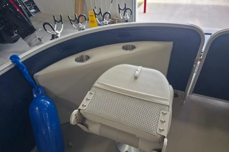 Slide: The Image of 2018 Manitou 22 Aurora LE Angler boat interior with fishing rod holders and seating. - 18