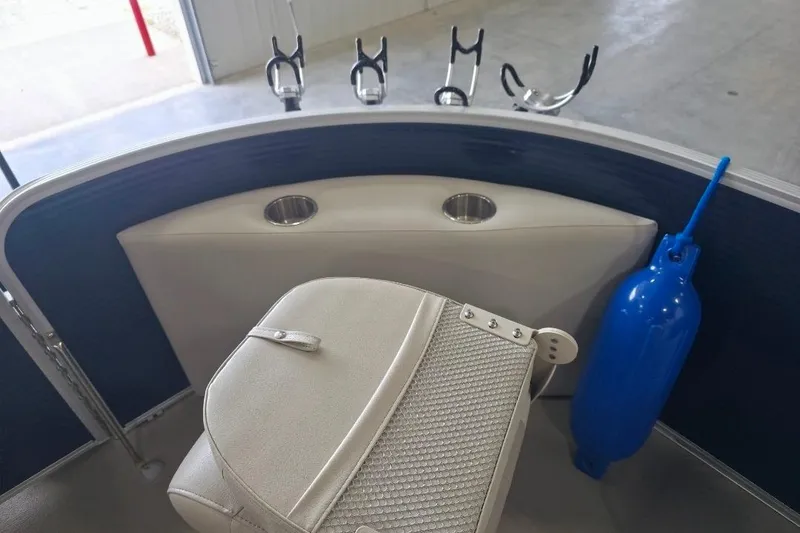 Slide: The Image of 2018 Manitou 22 Aurora LE Angler boat interior with rod holders and seating. - 19