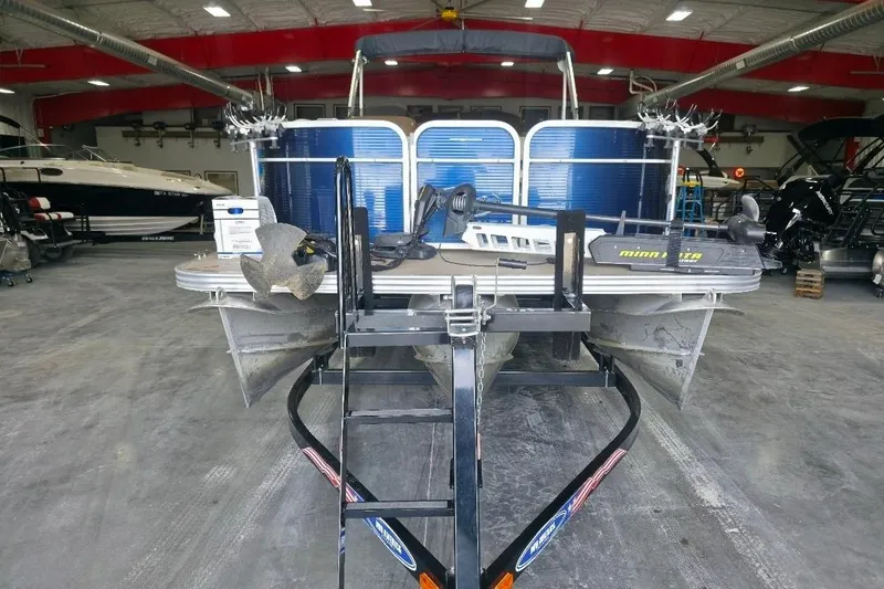 Slide: The Image of 2018 Manitou 22 Aurora LE Angler pontoon boat in a showroom, front view. - 3