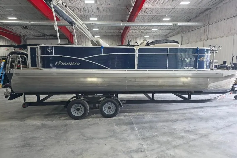 Slide: The Image of 2018 Manitou 22 Aurora LE Angler pontoon boat on trailer in indoor storage. - 4